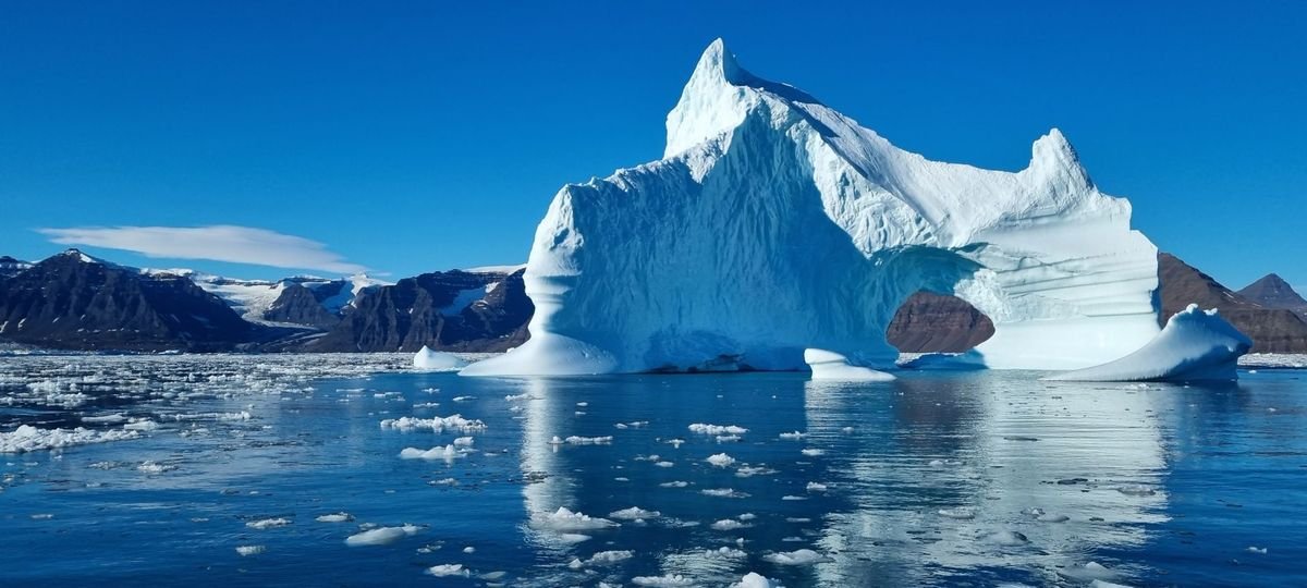 Iceberg floating in a fjord in Greenland
