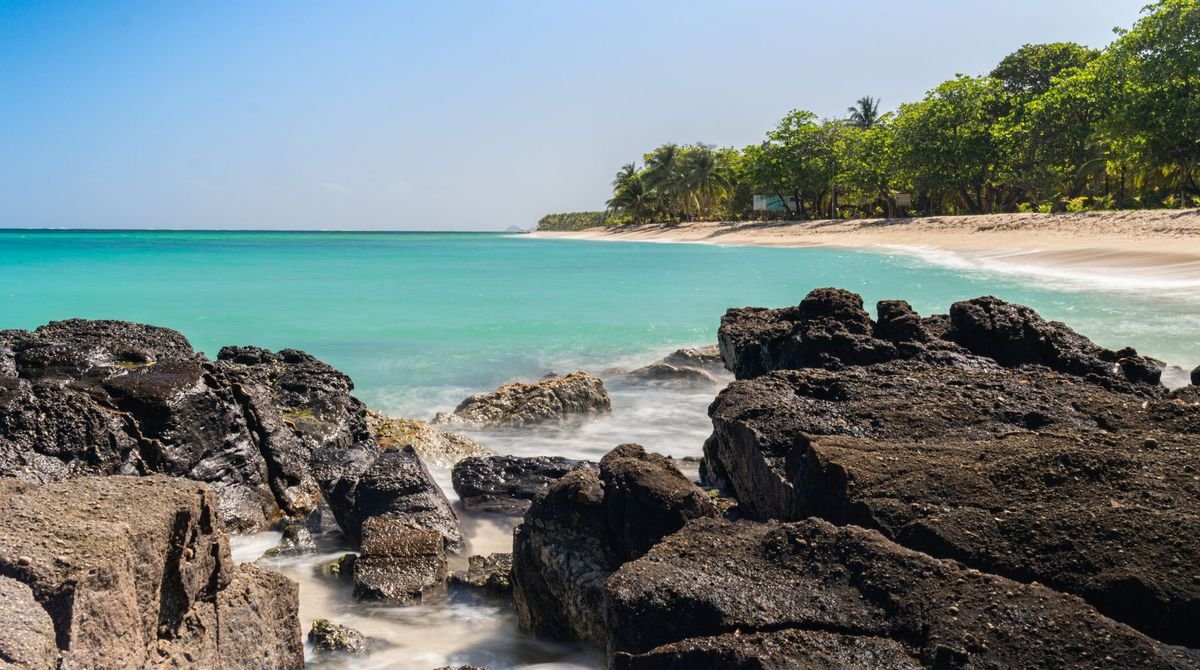 Rocky shore and turquoise sea on a beach in Guadeloupe
