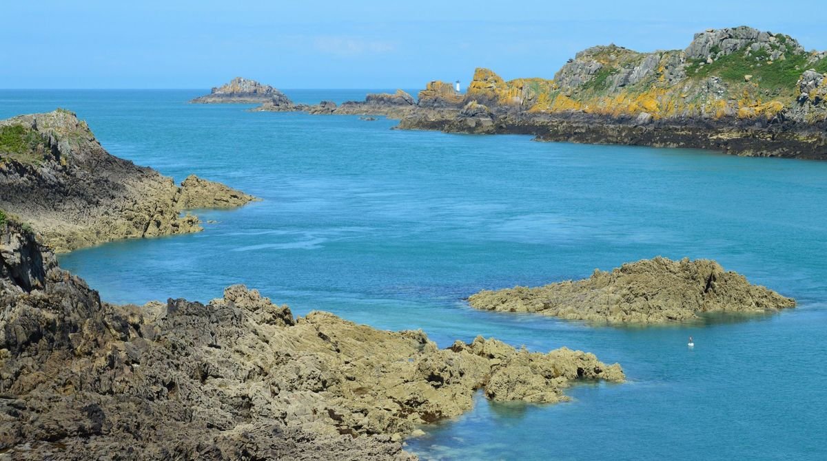 Rocky coves and clear blue water on the coast of Guernsey