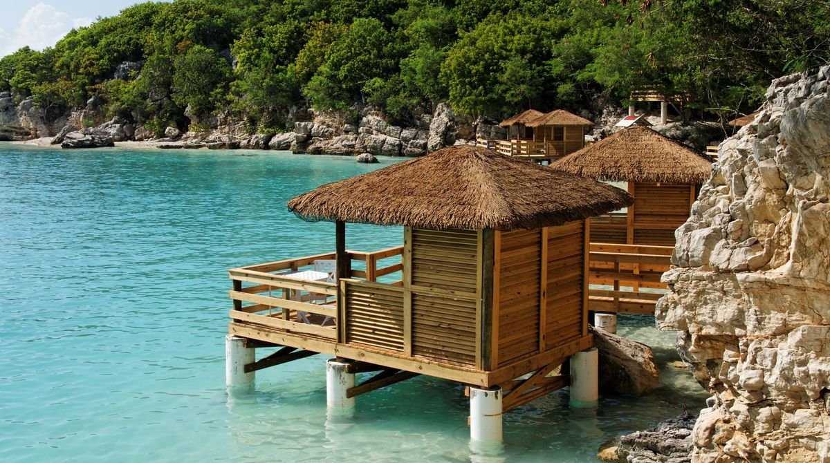 Wooden huts over turquoise water on the north coast of Haiti