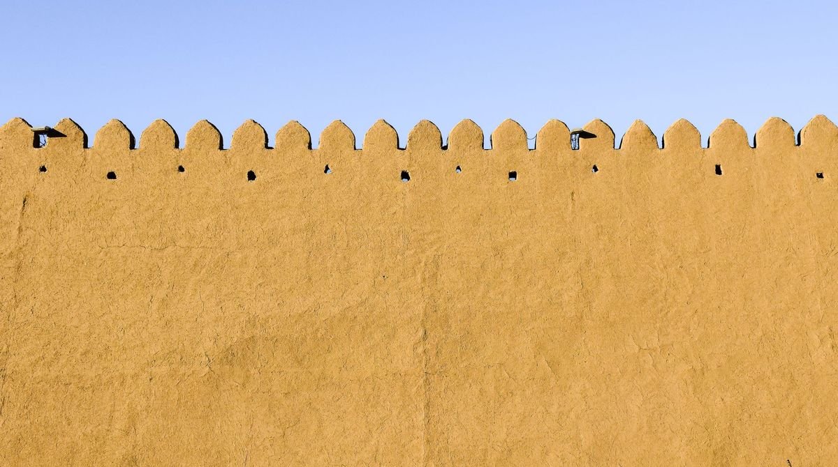 Sand-coloured citadel walls under a blue sky