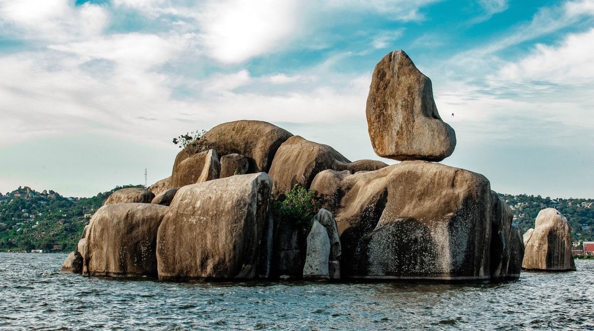 Granite boulders rising from calm lake water