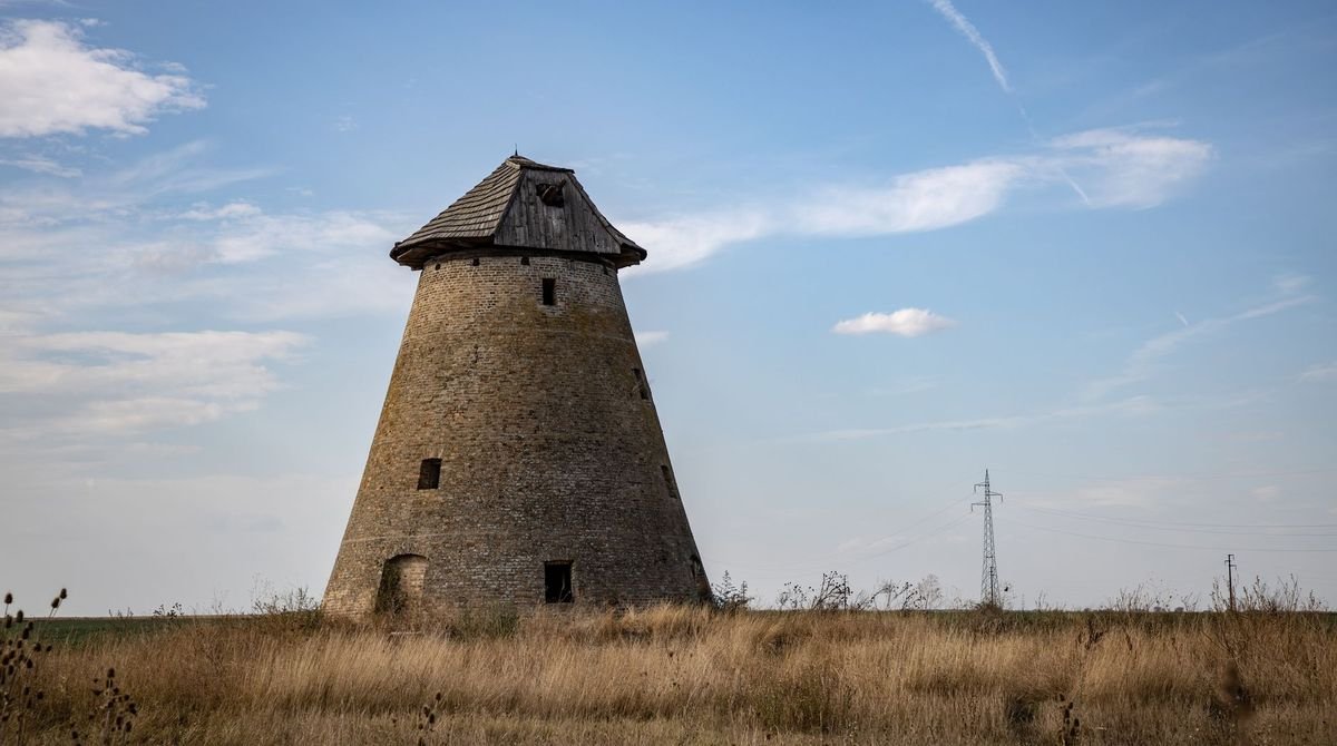 Old stone windmill tower in open countryside